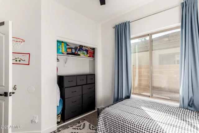 a view of cabinet with window and walk in closet