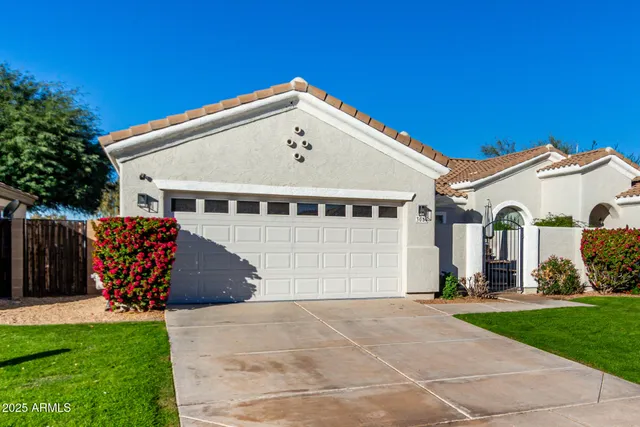 a view of a white house with a yard