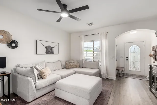 a living room with furniture and a wooden floor