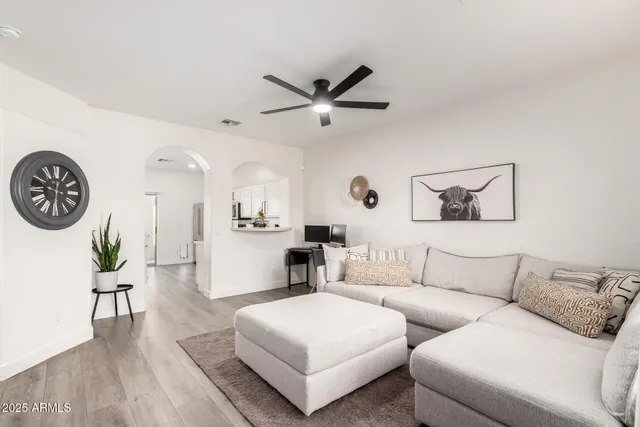 a living room with furniture and a wooden floor