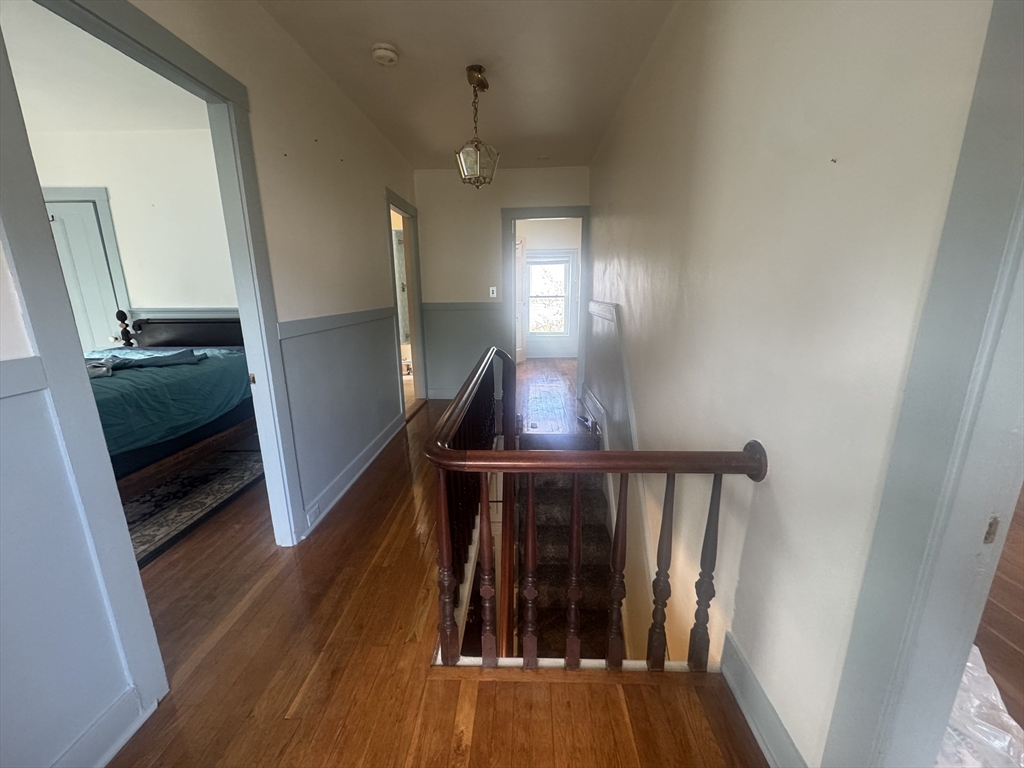 39 Belmont Street, Unit 2 Fall River, MA 02720 - Photo 6 of 10 a view of a hallway with wooden floor and staircase