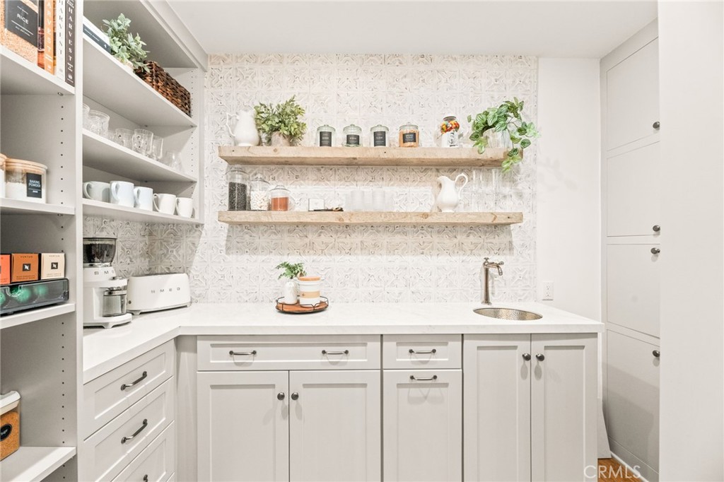 2933 Estancia San Clemente, CA 92673 - Photo 26 of 59 a kitchen with a sink a stove and cabinets