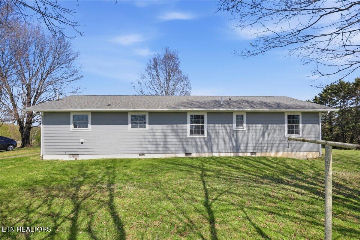 213 Lou Goddard Lane Greenback, TN 37742 - Photo 21 of 34 a front view of a house with a yard and garage