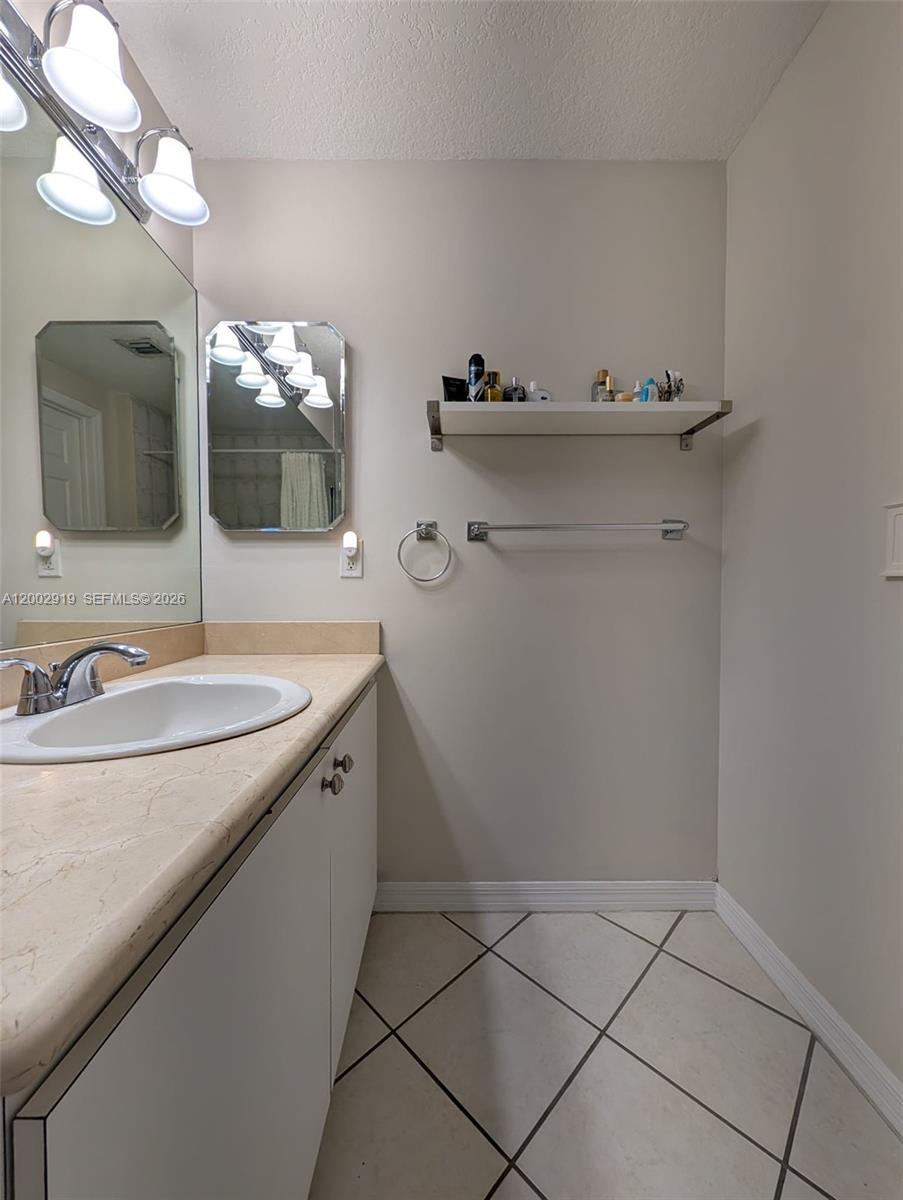 3500 Coral Way, Unit 505 Miami, FL 33145 - Photo 14 of 18 a bathroom with a sink and a mirror