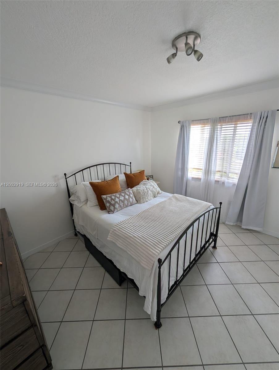 3500 Coral Way, Unit 505 Miami, FL 33145 - Photo 15 of 18 a bedroom with a bed and window