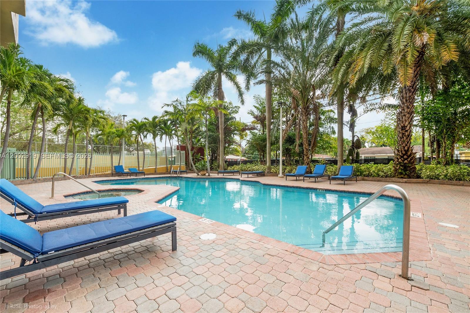 3500 Coral Way, Unit 505 Miami, FL 33145 - Photo 3 of 18 a view of swimming pool with chairs and trees