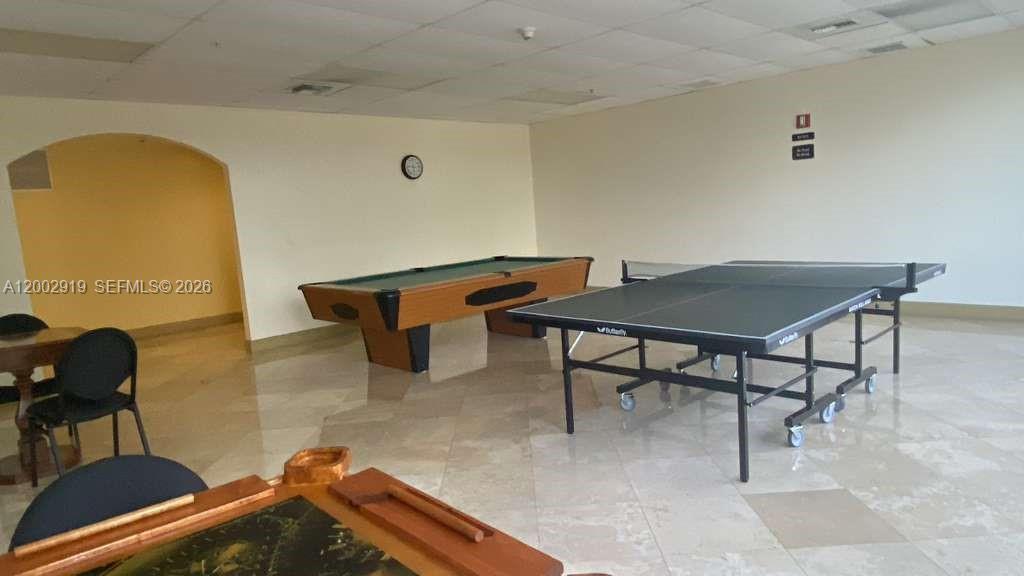 3500 Coral Way, Unit 505 Miami, FL 33145 - Photo 6 of 18 a reading room with furniture and wooden floor