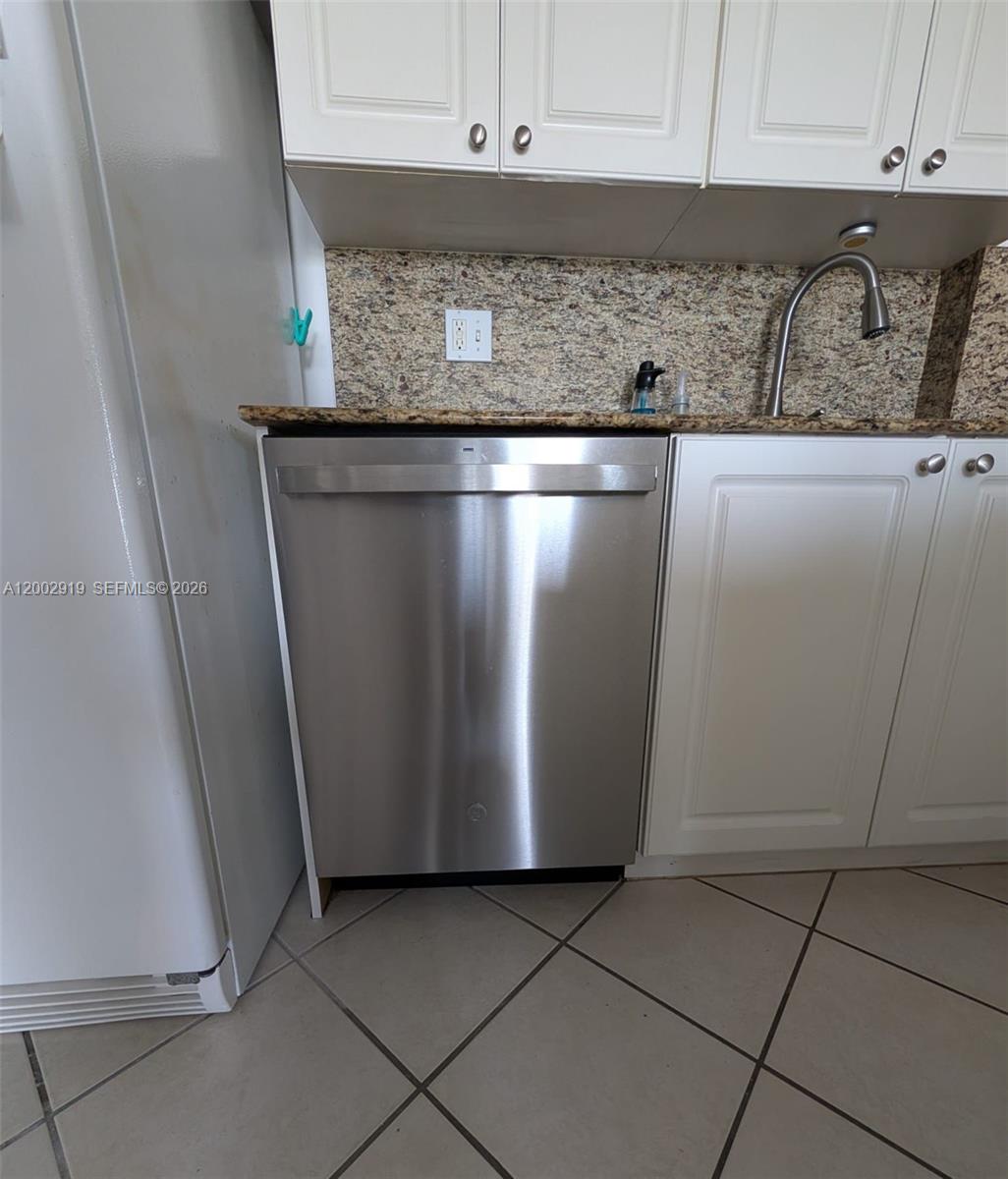 3500 Coral Way, Unit 505 Miami, FL 33145 - Photo 10 of 18 a kitchen with granite countertop a sink and a stove