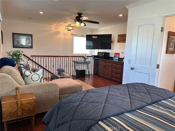 a bedroom with a bed and flat screen tv