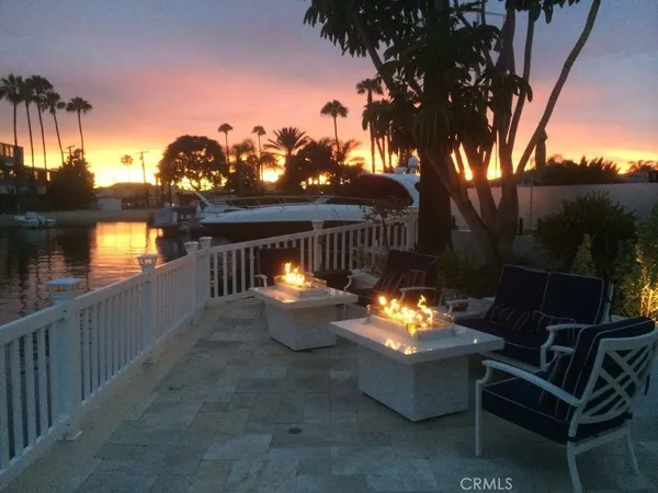 a backyard of a house with fire pit and outdoor seating