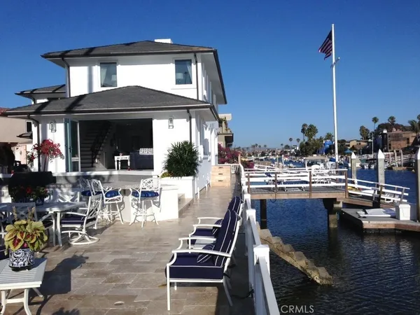 a view of a patio with dining table and chairs with barbeque grill and couches