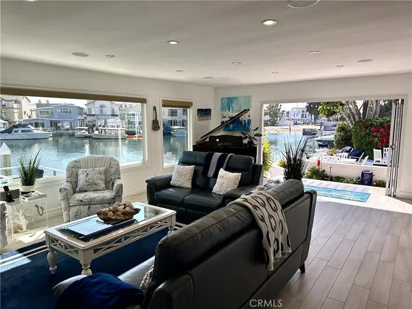 a living room with furniture and a floor to ceiling window