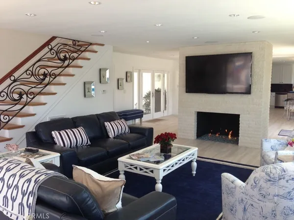 a living room with furniture fireplace and flat screen tv