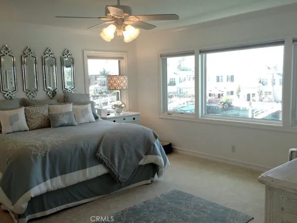 a spacious bedroom with a bed and a window