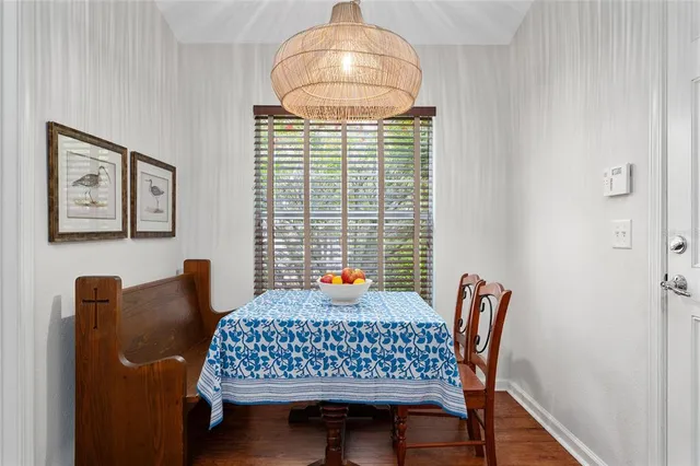 a kitchen with stainless steel appliances granite countertop a stove top oven a refrigerator a sink and dishwasher with wooden floor