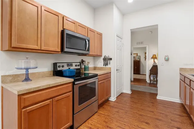 a kitchen with a sink and a wooden floor