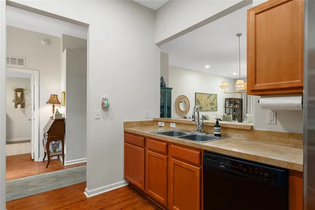 a view of a a dining room with furniture window and wooden floor
