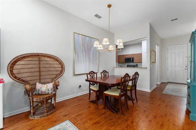 a living room with furniture a rug and wall painting