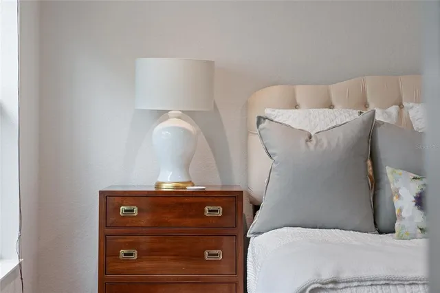 a bedroom with a bed and a large window