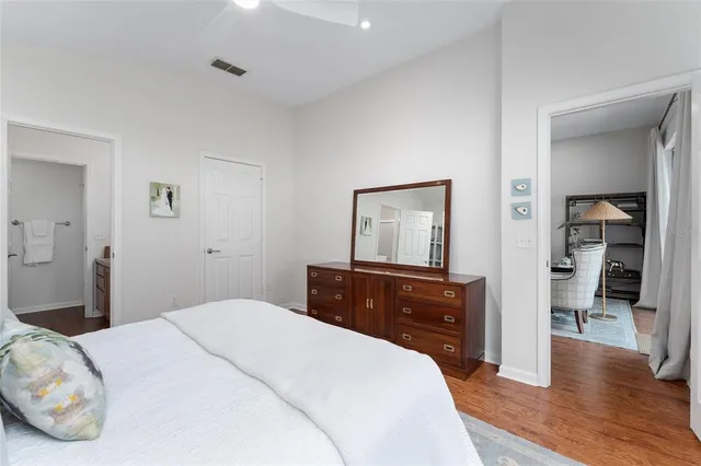 a bedroom with a bed and a large window