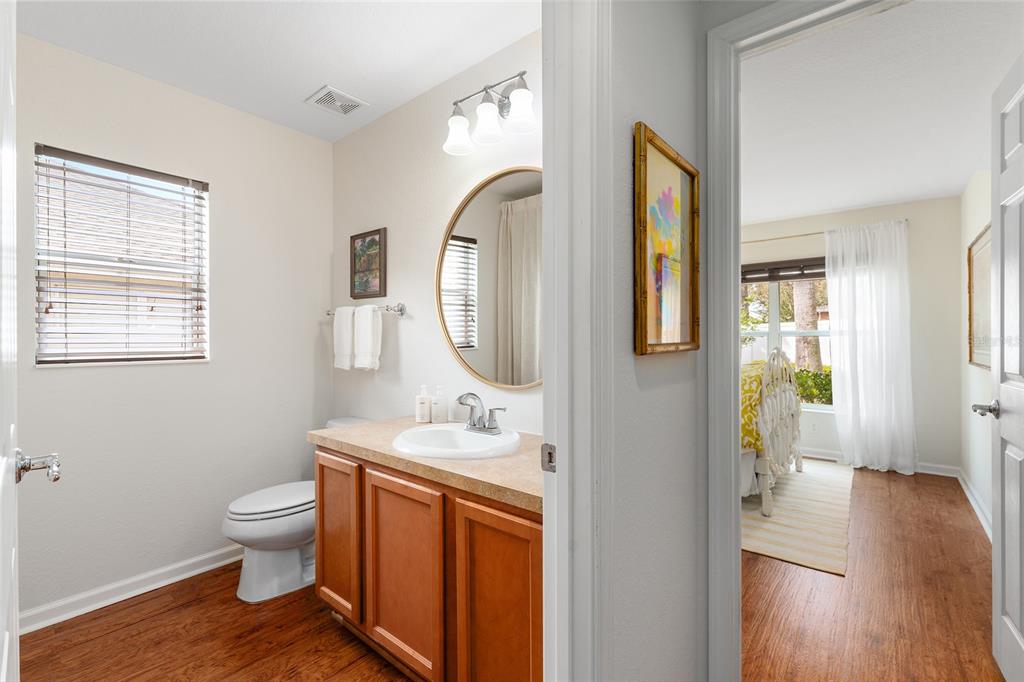 4080 Southwest 47th Court Ocala, FL 34474 - Photo 38 of 50 a bathroom with a granite countertop toilet a sink and a mirror