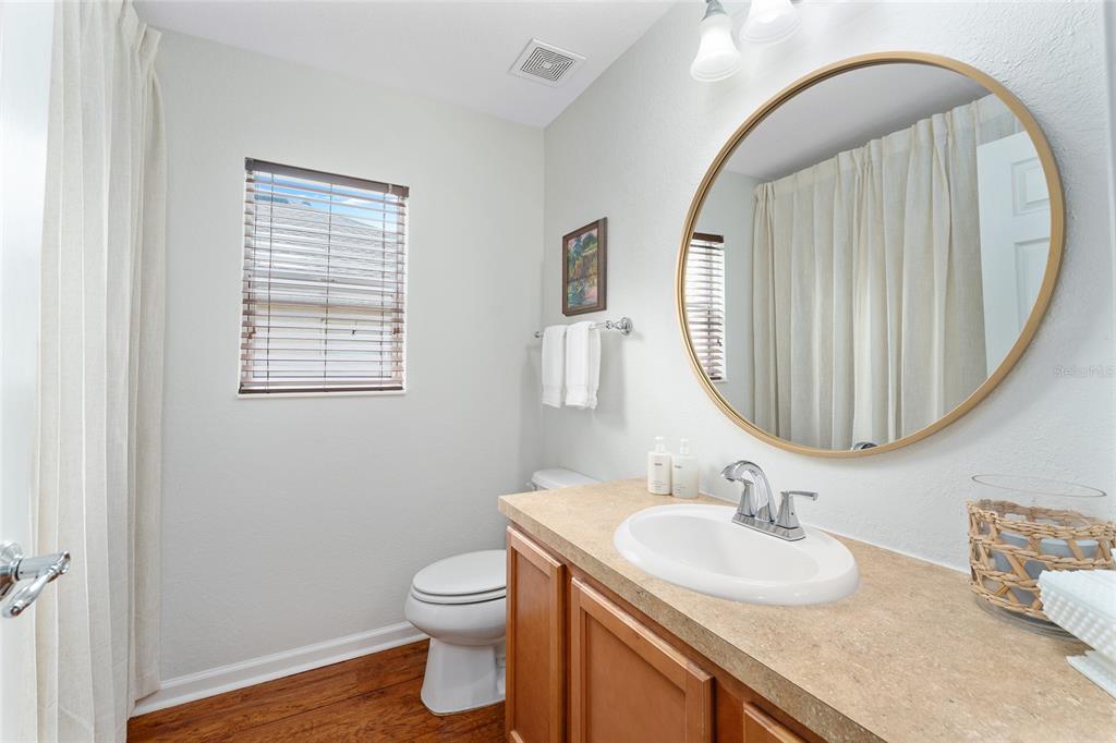 4080 Southwest 47th Court Ocala, FL 34474 - Photo 39 of 50 a bathroom with a granite countertop toilet a sink and a mirror