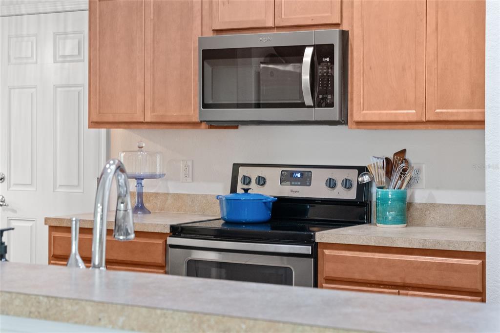 4080 Southwest 47th Court Ocala, FL 34474 - Photo 10 of 50 a kitchen with stainless steel appliances granite countertop a stove and a microwave with cabinets