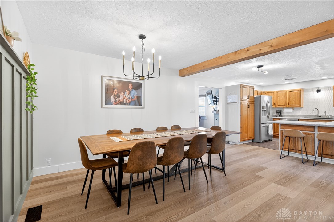 7888 Darke-Preble County Line Road Arcanum, OH 45304 - Photo 16 of 51 This open concept space seamlessly connects dining and kitchen areas, featuring hardwood flooring and natural light.