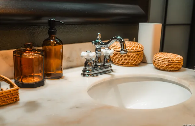 a kitchen with kitchen island granite countertop a sink stainless steel appliances and cabinets