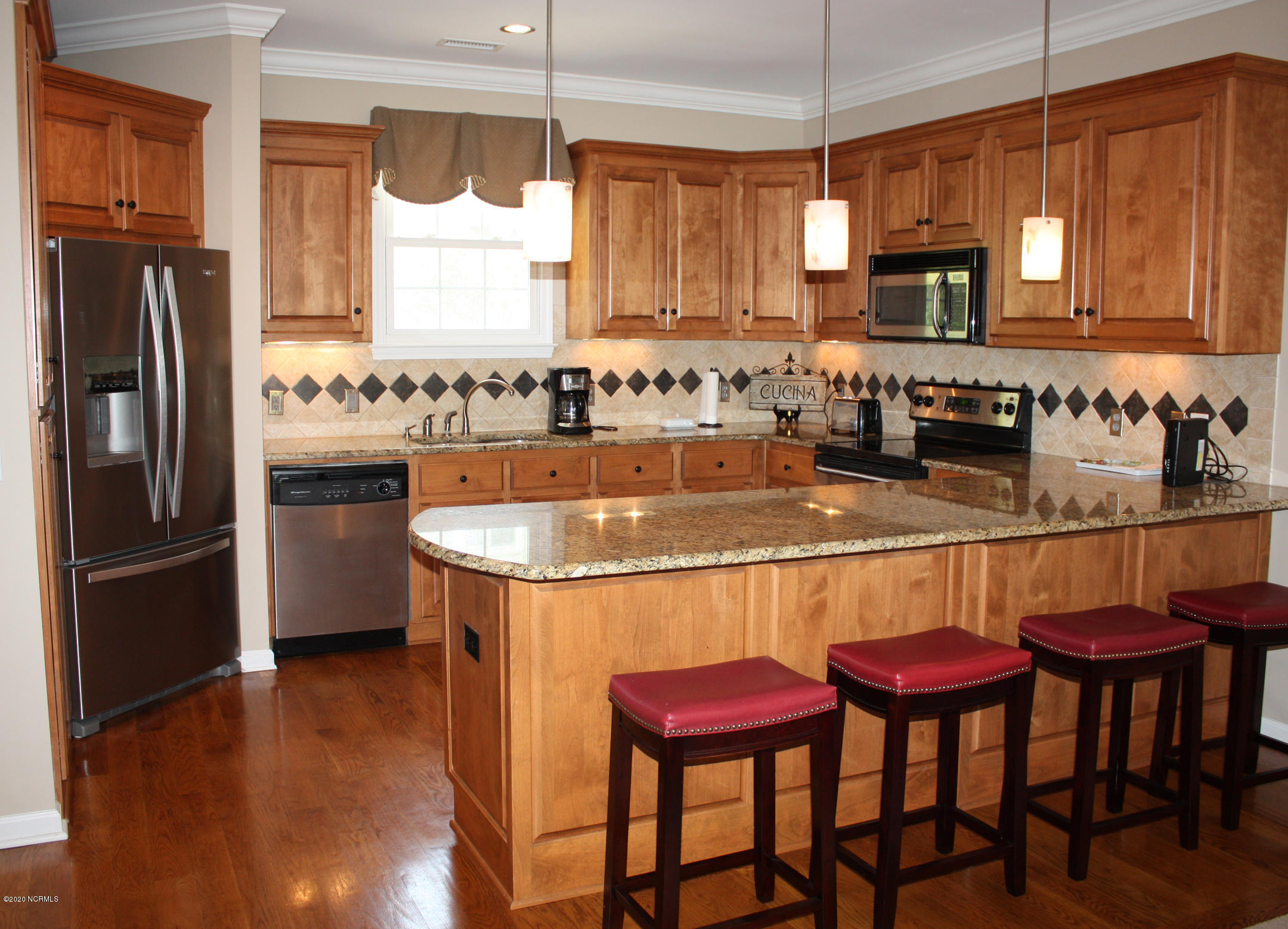 605 River Ridge Road, Unit 3 Shallotte, NC 28470 - Photo 4 of 34 Modern backsplash accentuates homey kitchen with long eat-at bar.