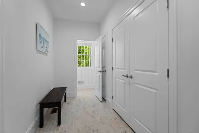 a view of a hallway with entryway door