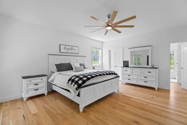 a bedroom with a bed and a chandelier