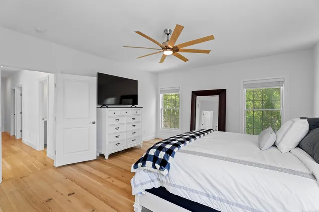 a bedroom with a bed and a flat screen tv