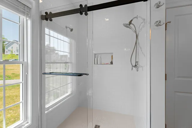 a bathroom that has a glass shower door