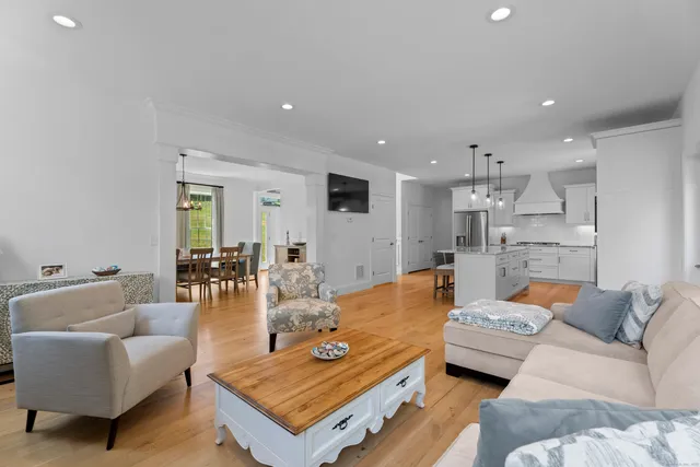 a living room with furniture and kitchen view