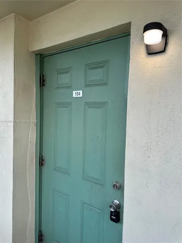 a kitchen with a refrigerator sink and cabinets