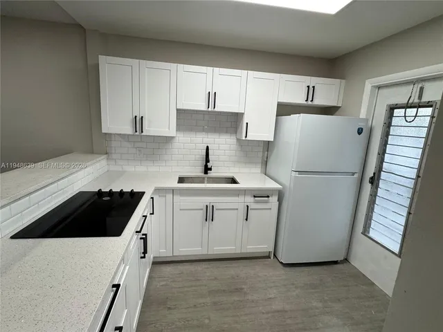 a kitchen with a stove and a sink