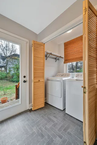 a utility room with cabinets dryer and washer