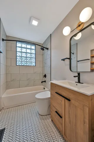 a bathroom with a toilet a sink and bathtub