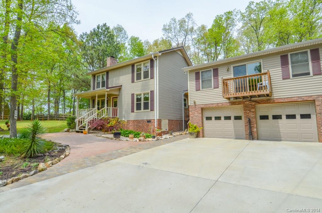 810 Old Williams Road Wingate, NC 28174 - Photo 2 of 24 a front view of a house with a yard and a garage