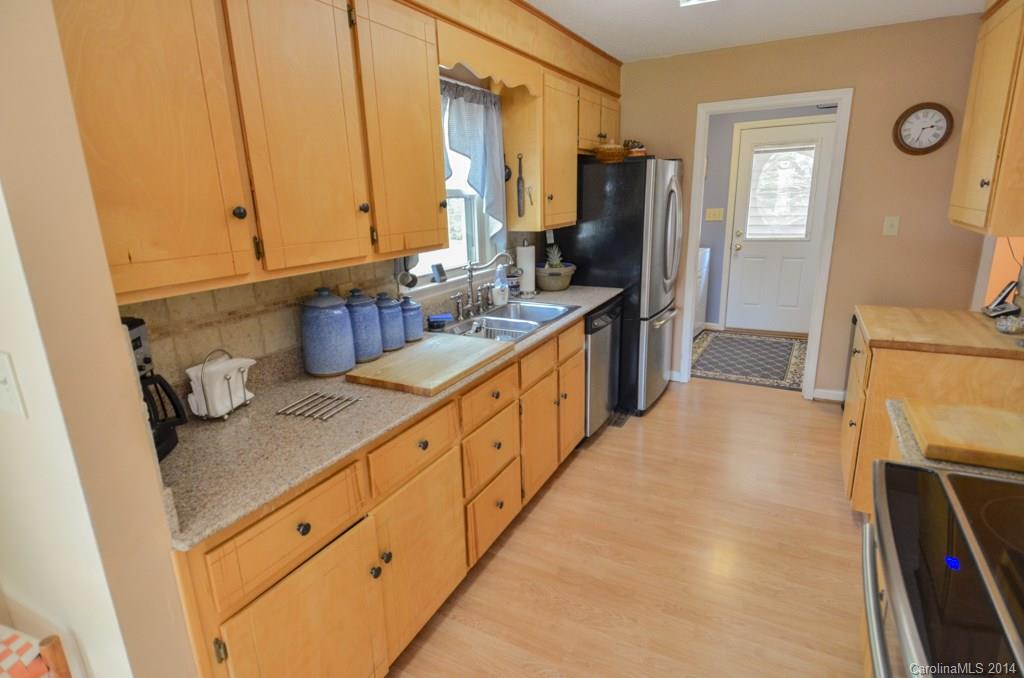 810 Old Williams Road Wingate, NC 28174 - Photo 11 of 24 a large kitchen with a sink a stove and a refrigerator