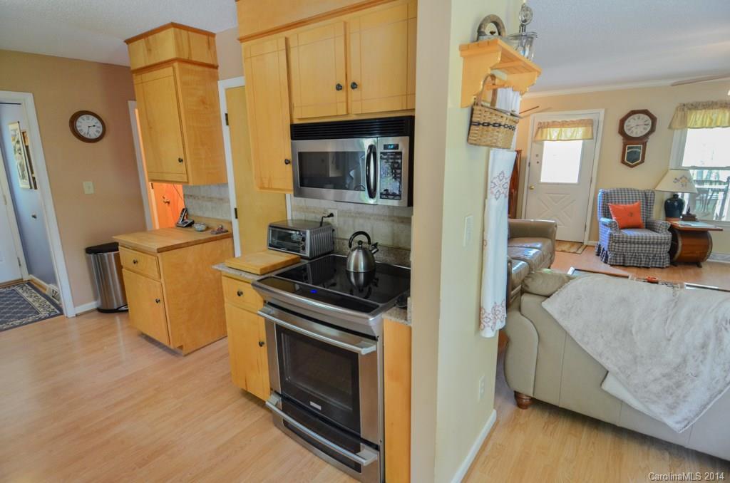 810 Old Williams Road Wingate, NC 28174 - Photo 13 of 24 a view of a kitchen with fridge and wooden floor