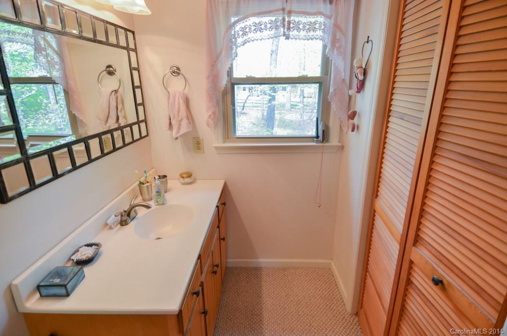 810 Old Williams Road Wingate, NC 28174 - Photo 21 of 24 a bathroom with a sink a mirror and a window