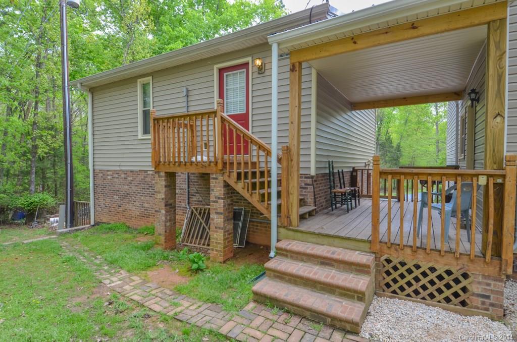 810 Old Williams Road Wingate, NC 28174 - Photo 23 of 24 a view of a house with backyard and wooden deck