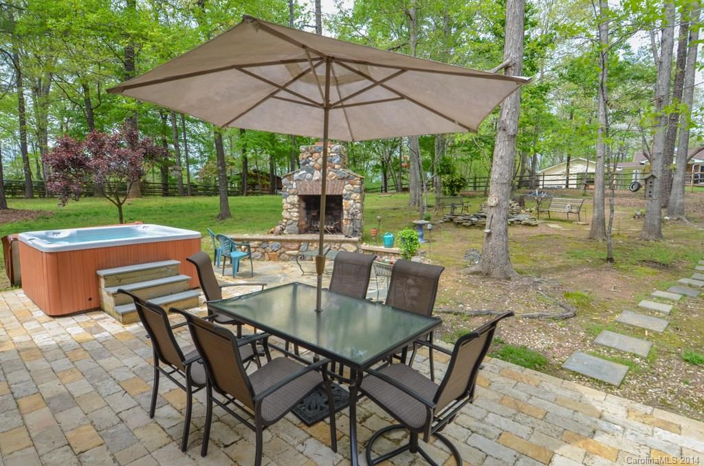 810 Old Williams Road Wingate, NC 28174 - Photo 5 of 24 a patio with a table and chairs under an umbrella