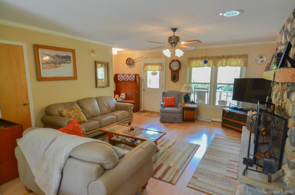 810 Old Williams Road Wingate, NC 28174 - Photo 9 of 24 a living room with furniture a flat screen tv and a large window