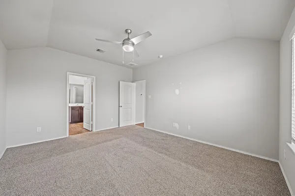 a view of an empty room with a ceiling fan