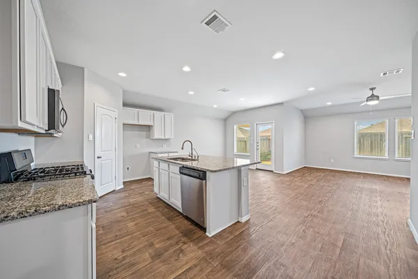 a kitchen with granite countertop a stove and a sink