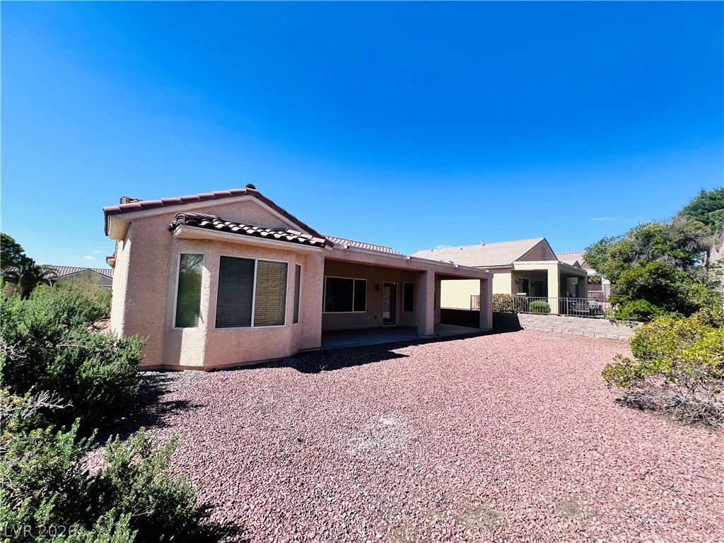 3047 Hickory Valley Road Henderson, NV 89052 - Photo 27 of 33 A spacious backyard with a covered patio offers ample room for outdoor activities.