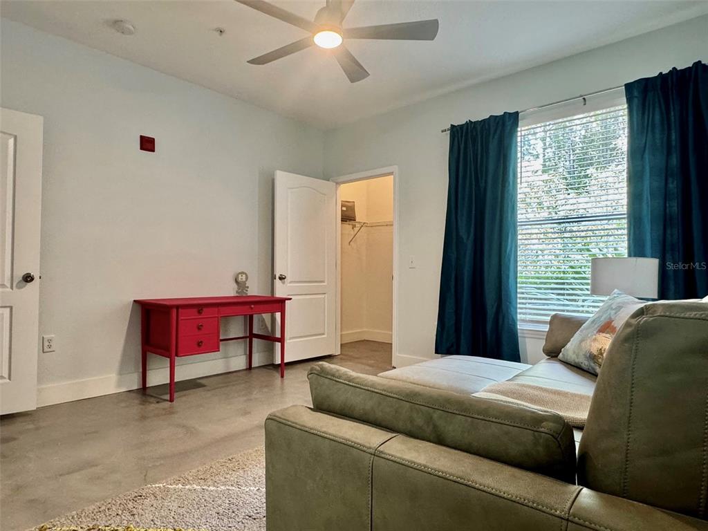 8842 Villa View Circle, Unit 108 Orlando, FL 32821 - Photo 12 of 25 a bedroom with furniture and a window